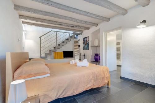 a bedroom with a large bed and a staircase at La Guardiola I By Immobilux in Riva del Garda