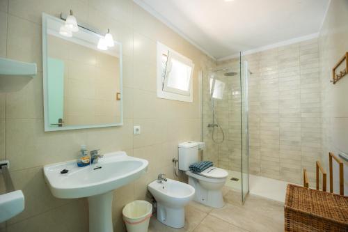 a bathroom with a sink and a toilet and a shower at Can Botana 9 in Cala de Sant Vicenc