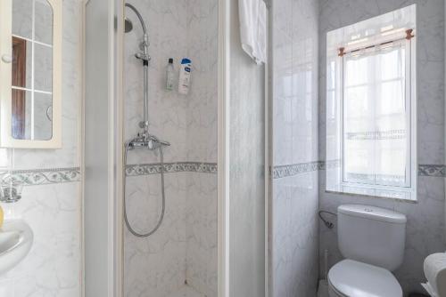 a bathroom with a shower and a toilet and a sink at Casa De Marica in A Estrada