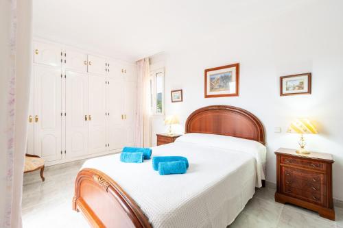a bedroom with a bed with blue towels on it at Villa Epi in Cala Ratjada