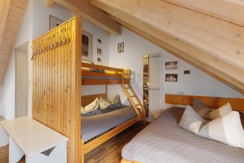 two bunk beds in a room with wooden walls at Ferienhaus Eifel Atrium in Zweifelscheid