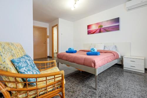 a bedroom with a bed and a chair at Masía Costa Daurada in Tarragona
