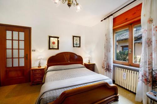 a bedroom with a bed and a window at Maison Lorent in Champdepraz
