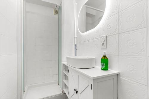 a white bathroom with a sink and a mirror at Véritable Mas Provençal À La Palud in La Palud-sur-Verdon