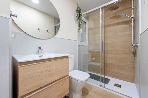 a bathroom with a shower and a toilet and a sink at beach and pool in Cambrils