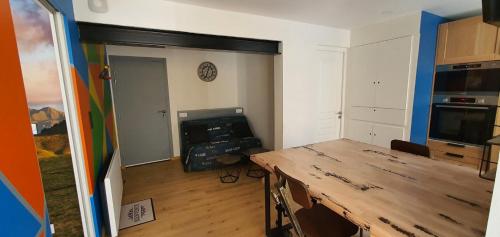 a room with a wooden table in a room at Appartement La Perle Du Sancy in La Bourboule