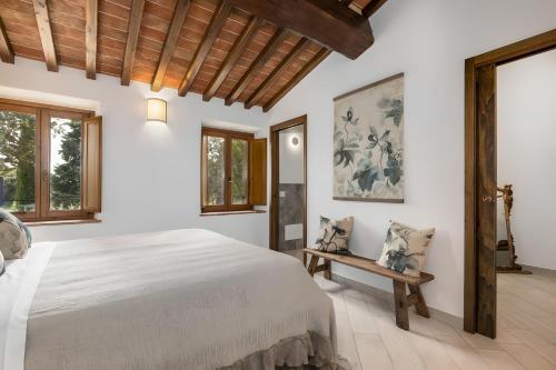 a bedroom with a large bed and a table at Villa Arnolfo in Colle di Val d'Elsa