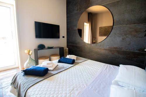 a bedroom with a large mirror and a bed at C-Home Historic House in Otranto
