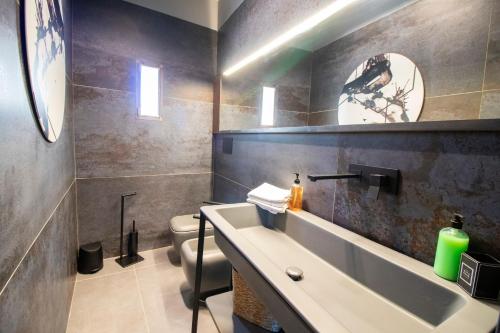 a bathroom with a sink and a toilet at C-Home Historic House in Otranto