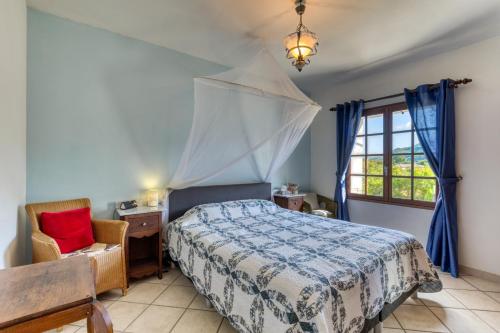 a bedroom with a bed and a desk and a window at La Trêve in La Tour-sur-Orb