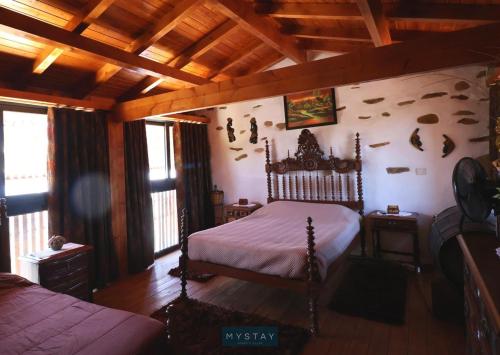 a bedroom with a bed in a room with wooden ceilings at Casa Alto Das Fragas in Canedo de Basto