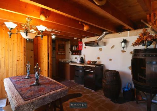a kitchen with a table and a stove at Casa Alto Das Fragas in Canedo de Basto