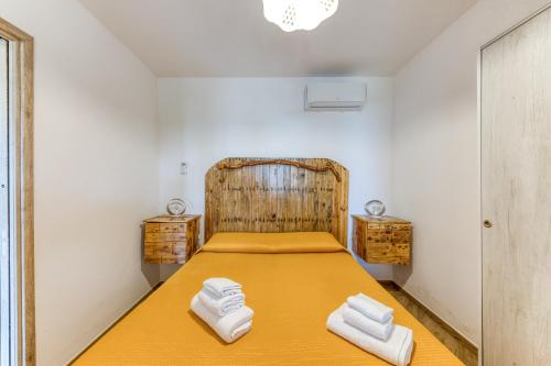 a bedroom with a bed with two towels on it at Villetta La Pajara in Morciano di Leuca