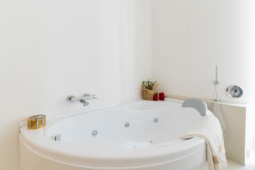 a white bath tub in a bathroom with a sink at Bacchus Historic Home in Otranto