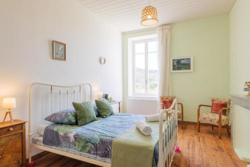 a bedroom with a bed and a window at Gîte Le Chant Des Oiseaux in Pradons