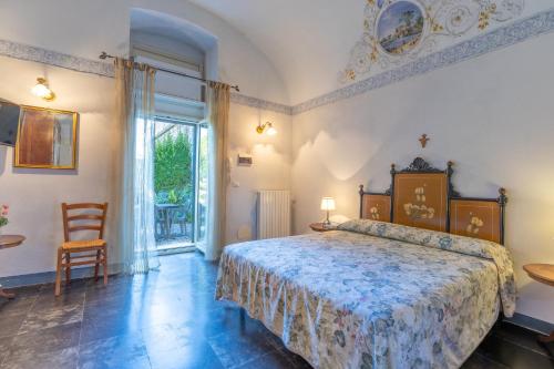 a bedroom with a bed and a large window at Villa Aguglie Con Piscina in Modica