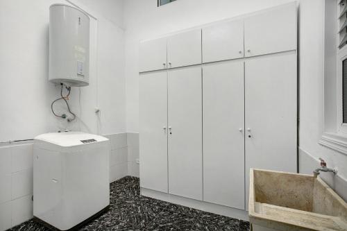 a bathroom with white cabinets and a sink at Los Morales in Arico
