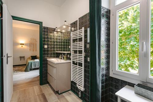a bathroom with a sink and a mirror at Chambre d'hote Emeraude in Genouillé
