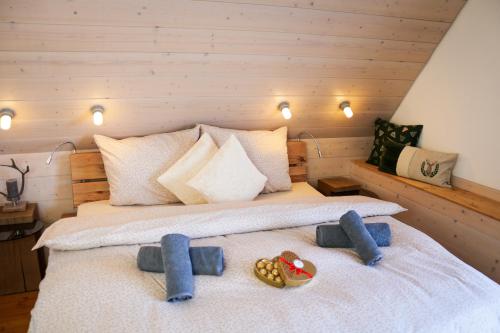 a bedroom with a bed with two shoes on it at Villa Wolfsgrund und Apt Wolfshöhle in Schluchsee
