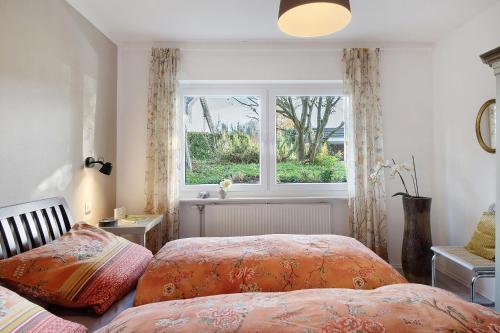 a bedroom with two beds and a window at Apartment Dreiländer Blick in Wintersweiler