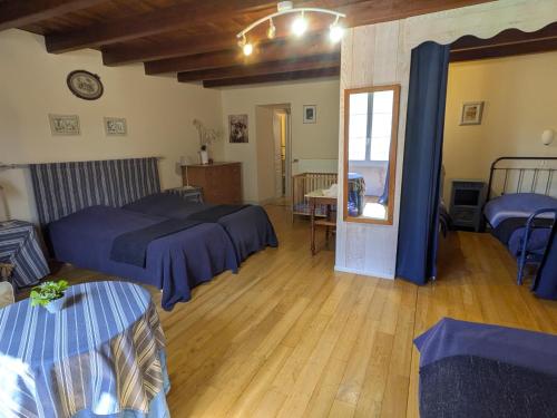a large room with two beds and a mirror at Domaine De Chante-Oiseau - 28 pers in Theil-Rabier