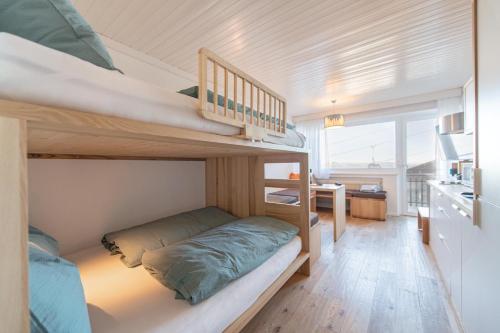 a small room with bunk beds and a desk at Mountain View Corones in Reischach