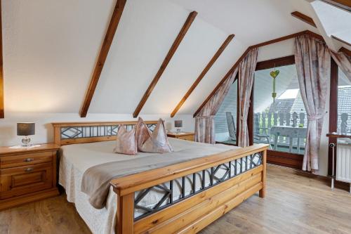 a bedroom with a bed and a large window at Haus Hachmann Wesselburen in Wesselburen