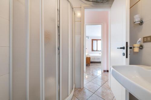 a bathroom with a shower and a sink and a tub at Tara house in Pula