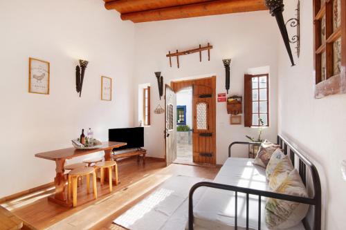 a living room with a couch and a table at Quinta do Mestre - Casa do Campo in Tavira