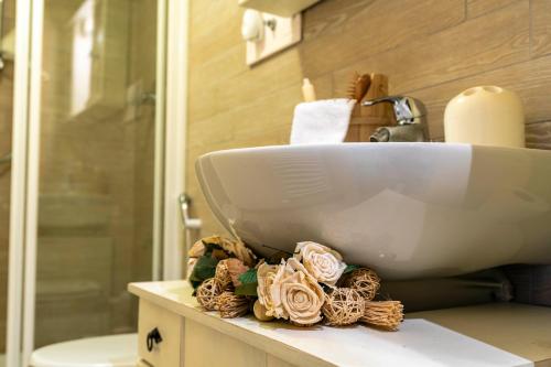 a bathroom with a sink on a counter with flowers at Modern Practical Studio In Sauze in Sauze d'Oulx