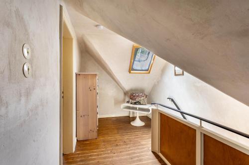 an attic hallway with a sink and a staircase at Haus Berlar in Bestwig