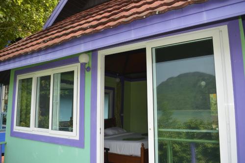 a purple house with a sliding glass door at Phi Phi View Point Resort in Phi Phi Don