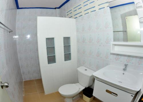 a bathroom with a white toilet and a sink at Phi Phi View Point Resort in Phi Phi Don