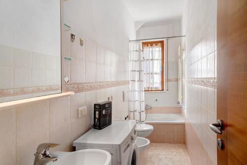 a white bathroom with a sink and a toilet at Casa di Lo in Laigueglia