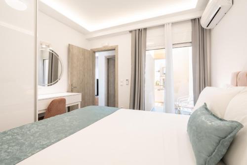 a bedroom with a bed and a desk and a mirror at Velvet Apartments in Rhodes Town