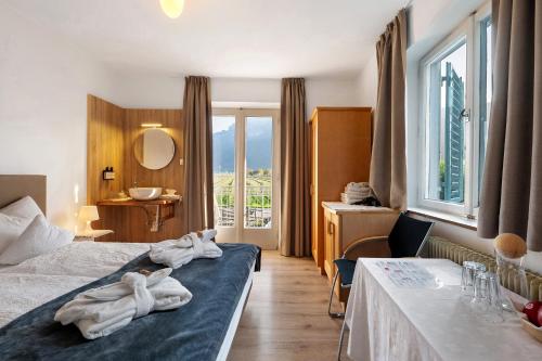 a hotel room with two towels on a bed at Haus Burger Vilpian in Vilpiano