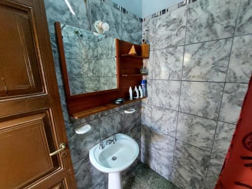 a bathroom with a sink and a mirror at Casa Manipa -3 dormitorios in Cafayate