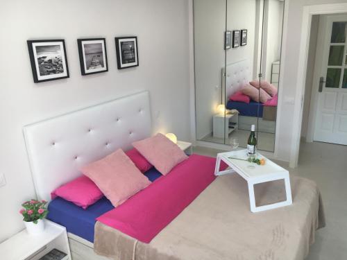 a bedroom with a large bed with pink pillows at Apartment Los Cristianos in Los Cristianos