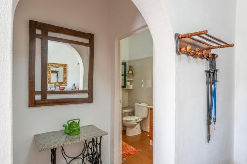 a bathroom with a toilet and a mirror on the wall at Casa Isabel in Tijarafe