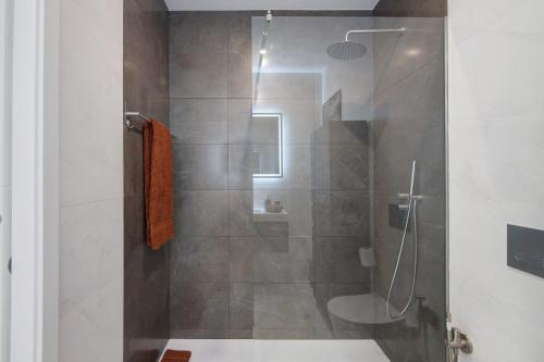 a bathroom with a shower with a toilet at The Olive Tree Apartment in Tavira