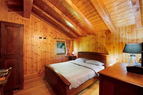 a bedroom with a bed in a wooden room at Anita Haus - Issime in Issime