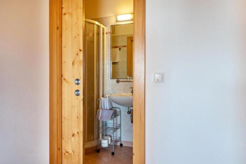 a bathroom with a sink and a mirror at Haus Alpenblick Apt Edelweiß in Laion