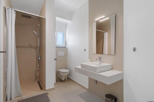 a bathroom with a sink and a shower and a toilet at Peace House Lourinhã - Villa 8 in Lourinhã