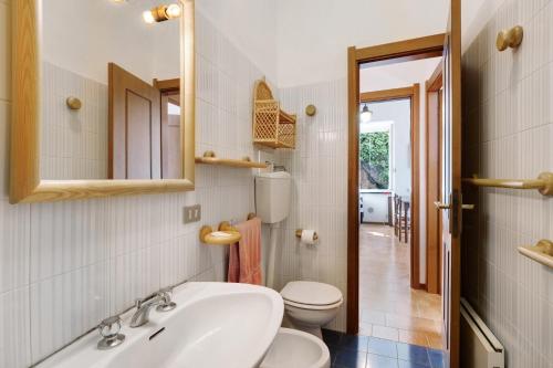 a bathroom with a sink and a toilet and a mirror at Bilo Costella in Bonassola