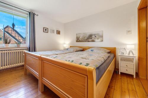 a bedroom with a large bed and a window at Weserberglandblumen in Bad Pyrmont