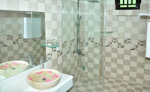 a bathroom with a shower with a sink and a toilet at Bi's House Homestay in Hoi An