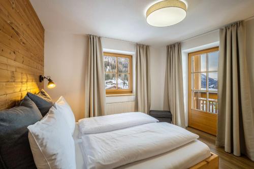 a bedroom with a bed and a window at Mountain Residence Kasern Nr 1 in Predoi