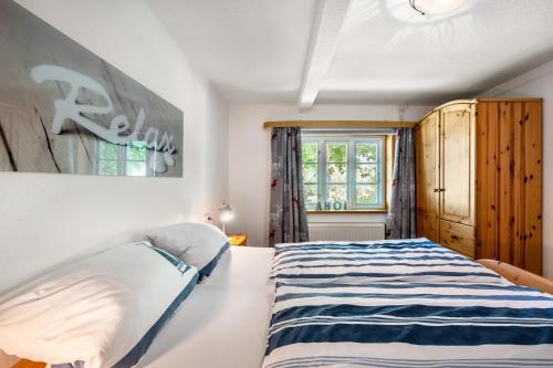 a bedroom with a large bed and a window at Fewo Silke Dethlefsen in Pellworm