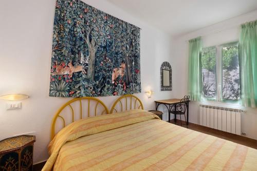 a bedroom with a bed and a large painting on the wall at Agriturismo La Realidad in Finale Ligure