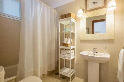 a bathroom with a sink and a shower curtain at Apartamento Marina in Arona